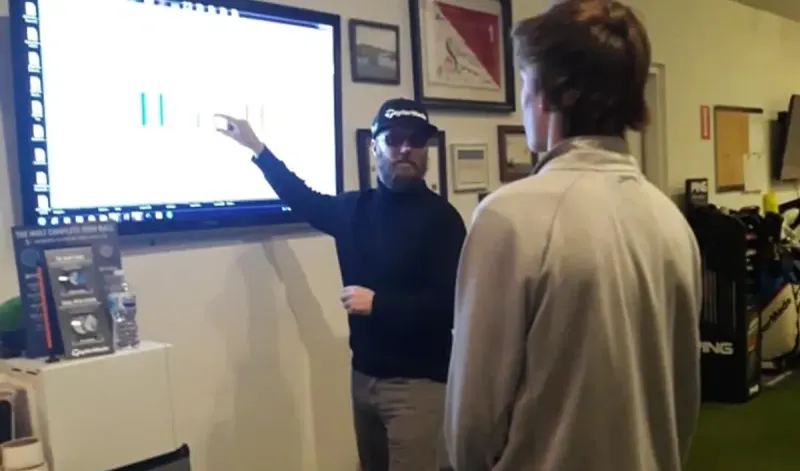 Jaime going over results on the big screen with a student